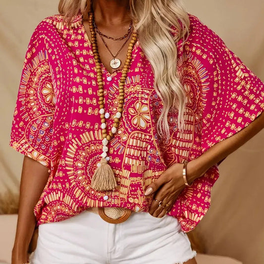Top holgado de mujer con cuello en V y estampado, con mangas murciélago, ideal para vacaciones.